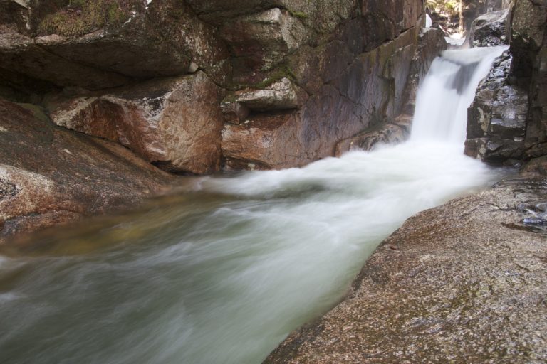 Rushing Stream Carving Through Rock