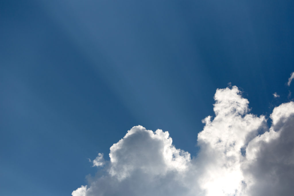 Sun Breaking Through Puffy Cloud