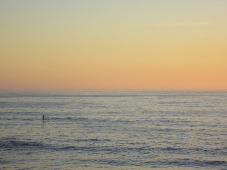 Person on the Ocean at Sunset