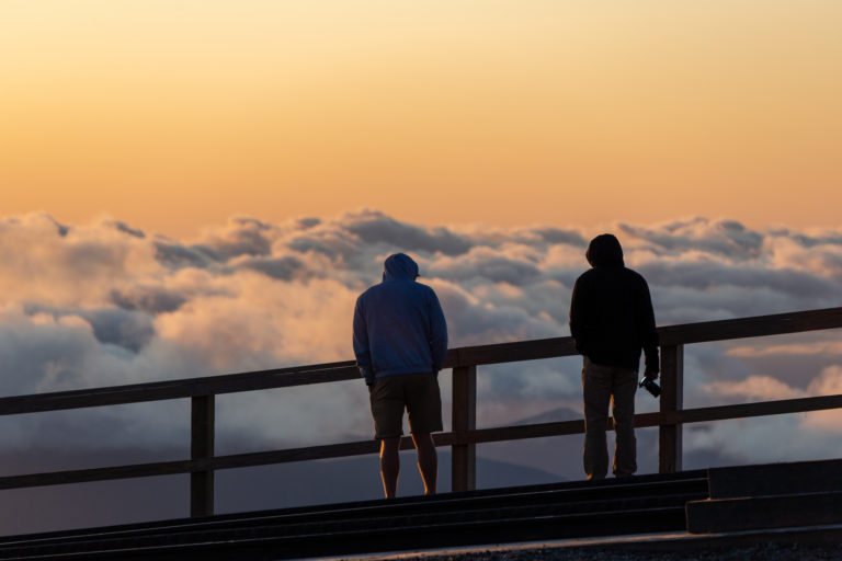 People Silhouettes Over Clouds