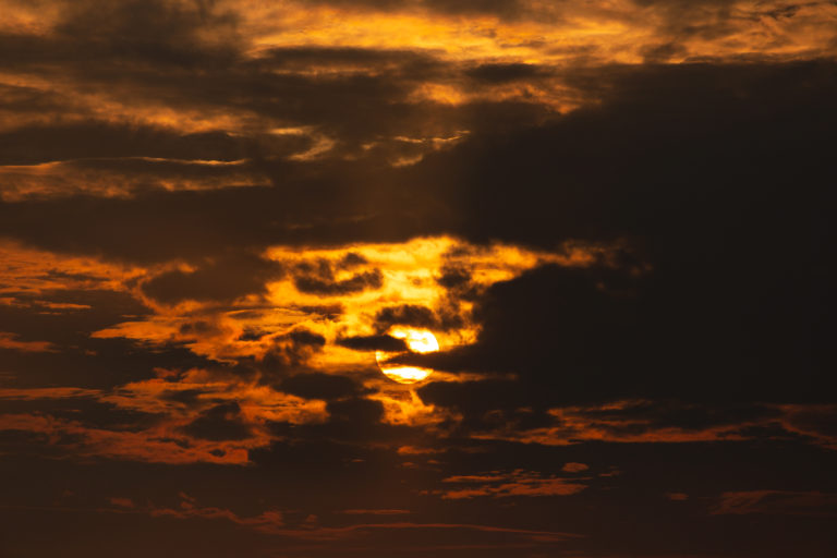 Peek of Sunset Through Dark Clouds