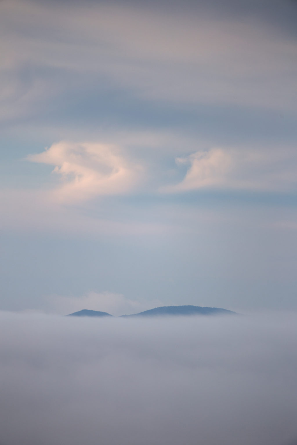 Mountaintop Peeking Over Thick Cloud Cover