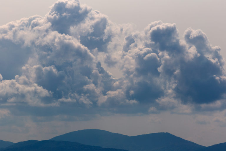 Moody Rolling Clouds Over Mountains