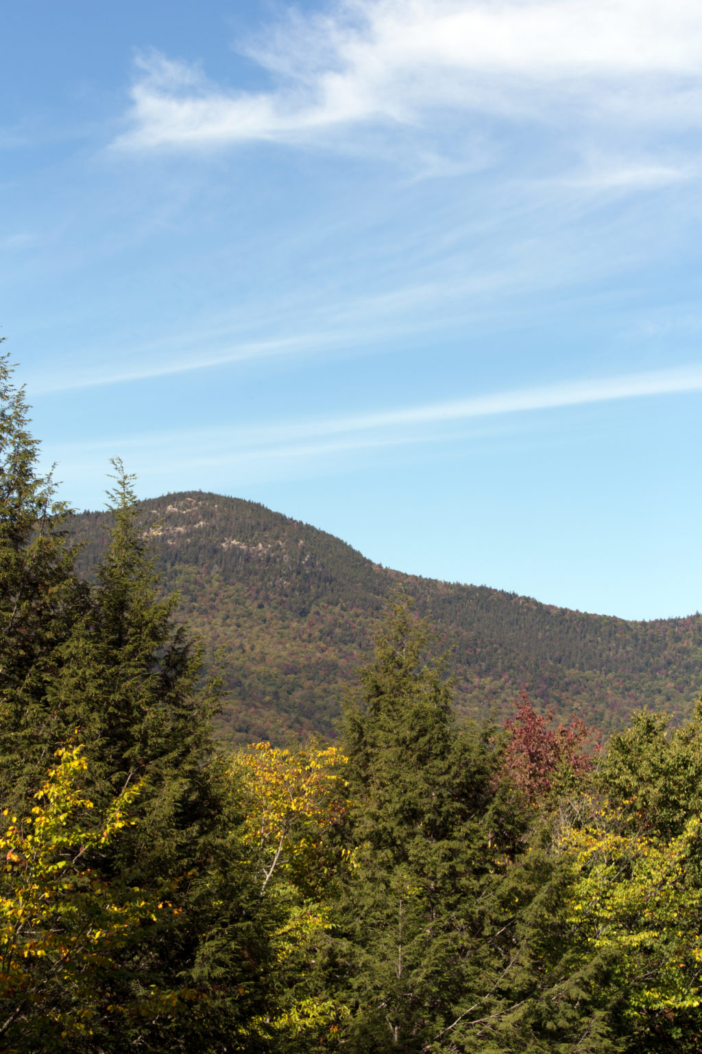 Rolling Green Mountain Under Blue Sky