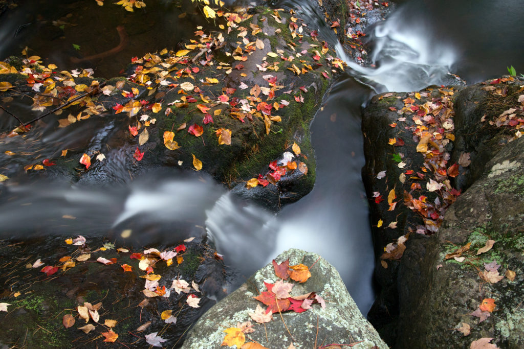 Misty Stream Flowing Through Rocks