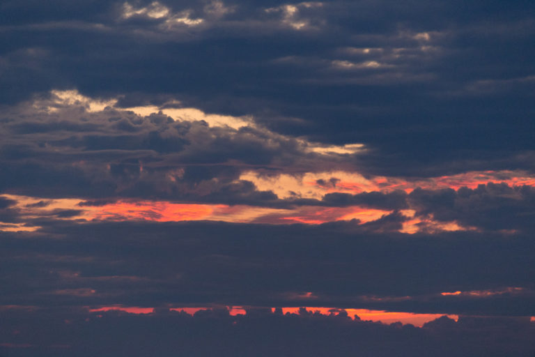 Peeks of Orange Sky Through Thick Clouds