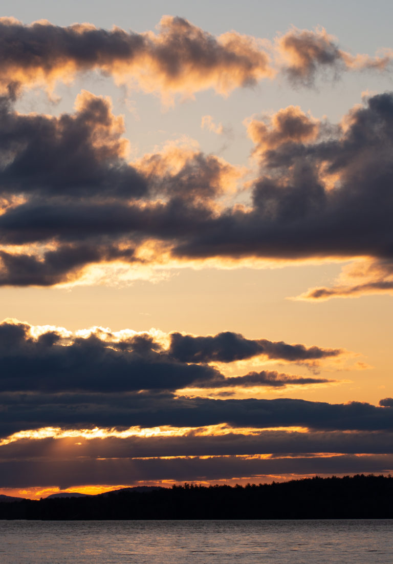 Cloud Silhouettes Against Golden Sunset Sky