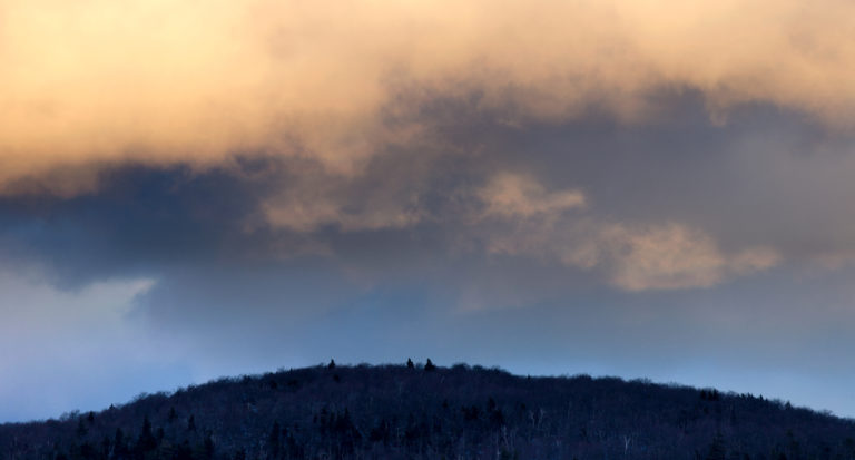 Glimpse of Mountains Under Clouds