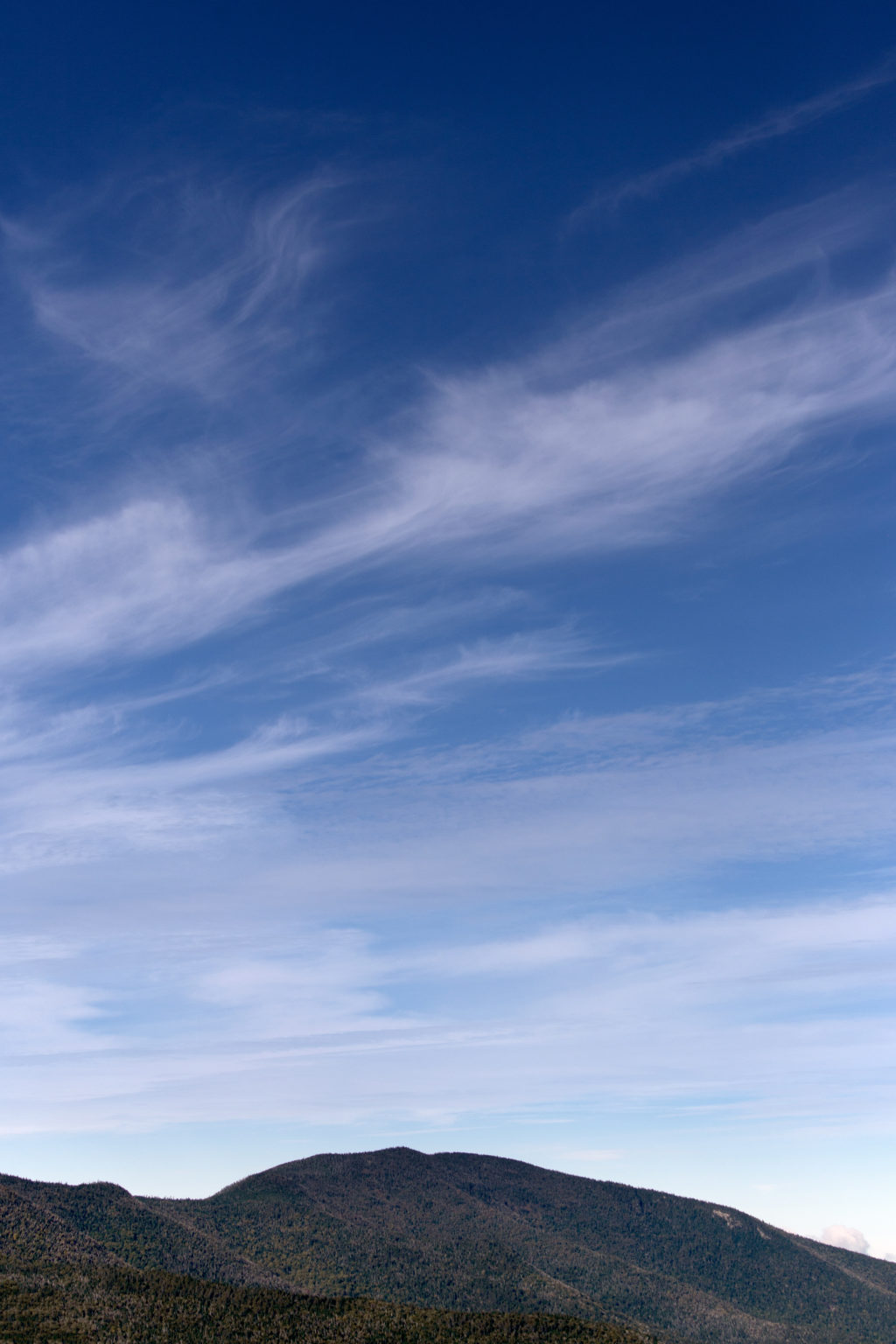 Mountaintop Under Blue Skies